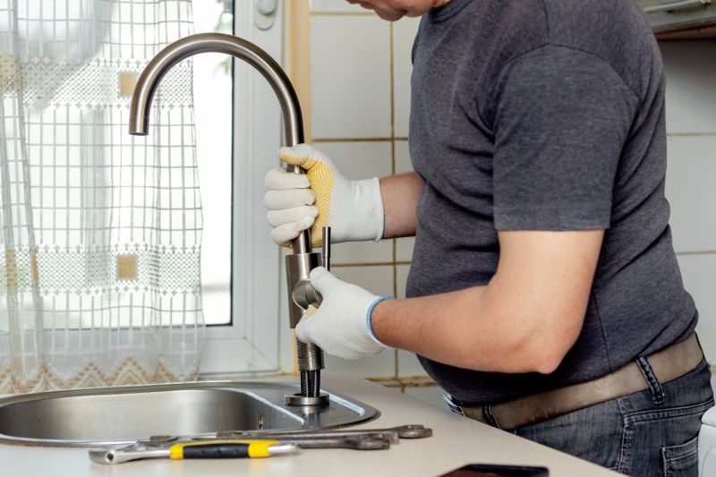 Handyman Fixing a Leaky Faucet